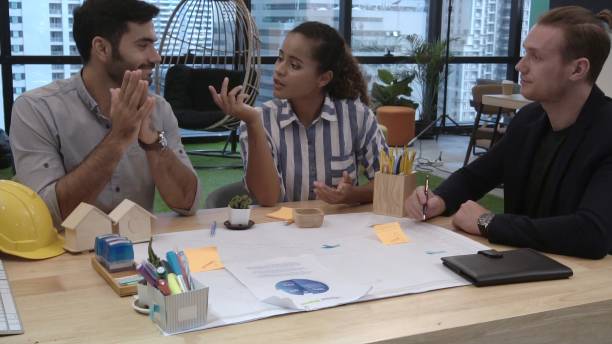 istock Creative business people group having conversation at office desk in workplace. 1187267066