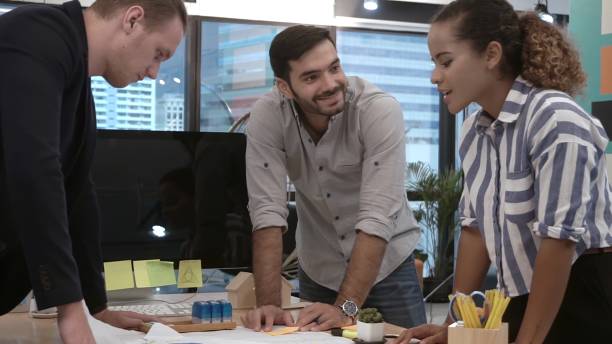 istock Creative business people group having conversation at office desk in workplace. 1187267069