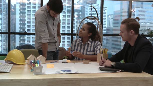 istock Creative business people group having conversation at office desk in workplace. 1187267077