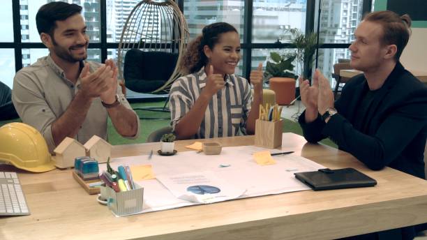 istock Creative business people group having conversation at office desk in workplace. 1187267084
