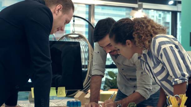 istock Creative business people group having conversation at office desk in workplace. 1187267087