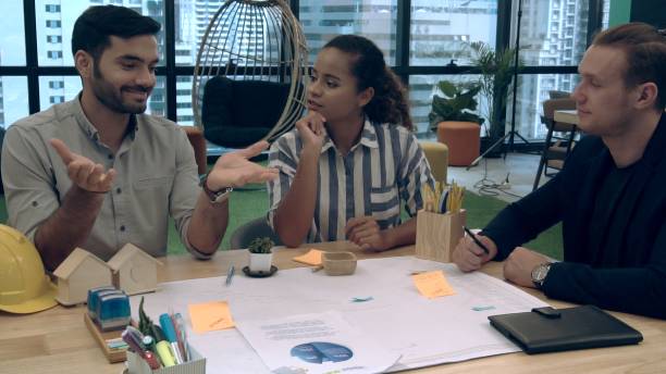 istock Creative business people group having conversation at office desk in workplace. 1187267095