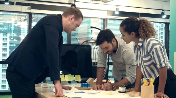 istock Creative business people group having conversation at office desk in workplace. 1187267097
