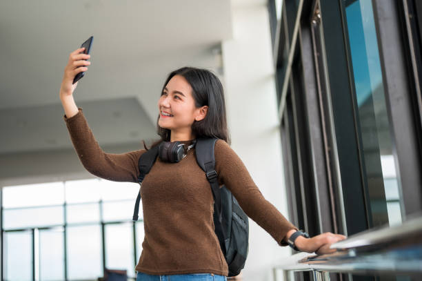 istock Long haired female student taking a selfie at the university 1187272798