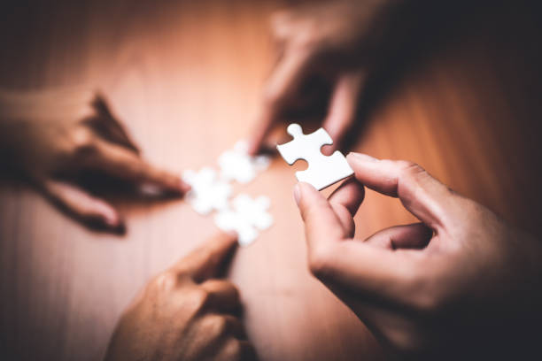 istock Hand holding jigsaw puzzles, Business partnership concept. 1187276019