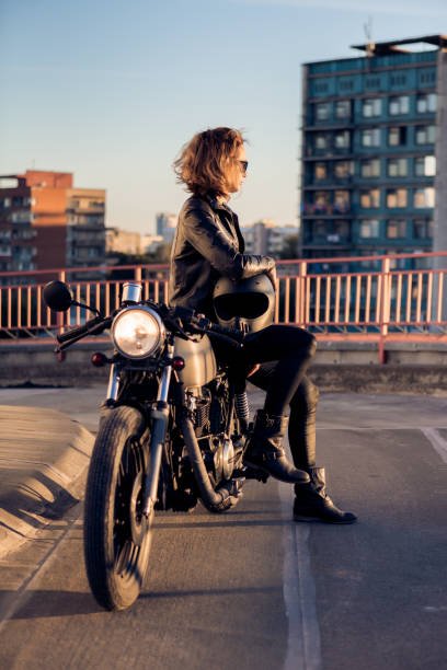 istock Biker girl on caferacer motorcycle. 1187279524