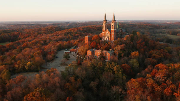 Aerial view of a church on the top of hill and autumn forest, red foliage . Fall season, autumn colors. Countryside, Wisconsin. Drone shots at sunset Aerial view of a church on the top of hill and autumn forest, red foliage . Fall season, autumn colors. Countryside, Wisconsin. Drone shots at sunset milwaukee wisconsin photos stock pictures, royalty-free photos & images