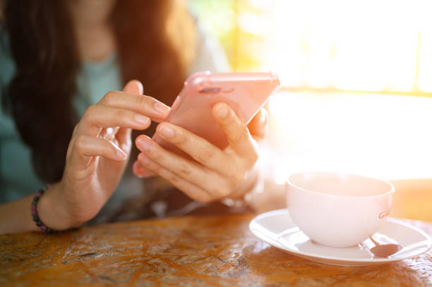istock The woman's hand uses a mobile phone at a coffee shop 1187289947