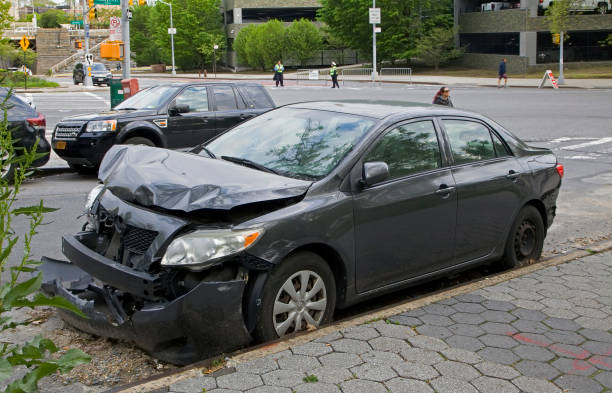 Vehicle parked on curb showing damage from a wreck stock photo