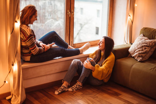 istock friends talking together at home 1187291129