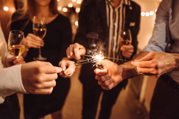 friends using the sparkler at home to celebrate new year