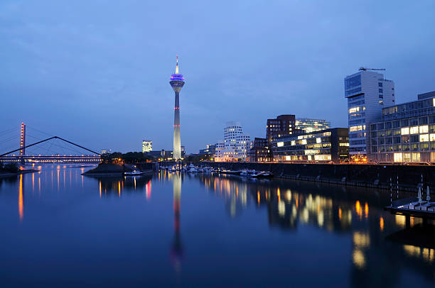 Night scene in Düsseldorf at the Rhine river with the Rheinturm Tower.