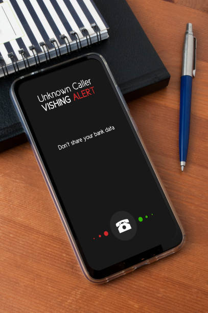 istock A smartphone leaning against a diary and a notepad on a wooden table show an unknown caller call with an alert and a reminder to not share personal bank data 1187299519