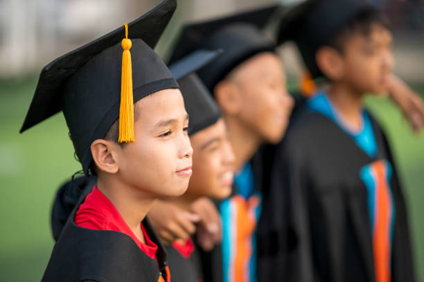 A group of boys are happy on their graduation day at school. stock photo
