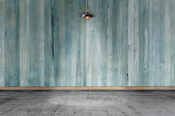 istock Empty room - wooden wall with lamp and laminate flooring. User for background 1187300439