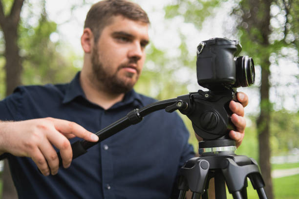 istock Videographer shoots video in a green park. 1187301918