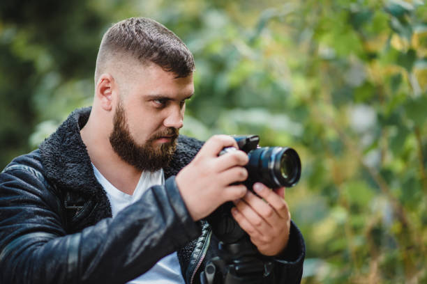 istock Videographer shoots video in a green park. 1187302188