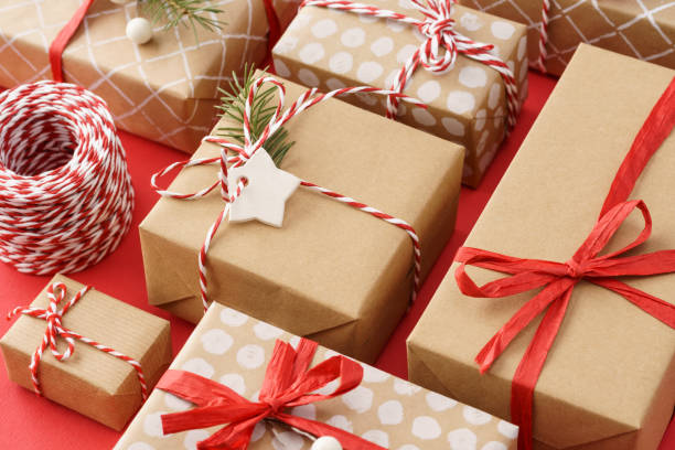 istock Paper wrapped gift boxes decorated with red ribbon and twine. 1187303098