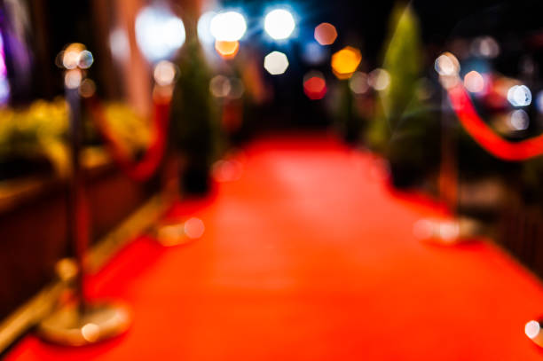 Long red carpet between rope barriers on entrance.