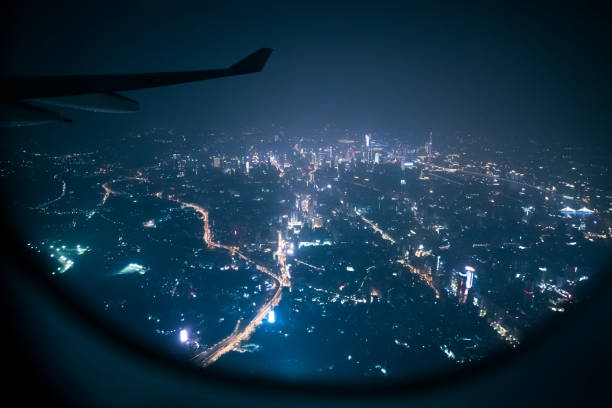 Looking guangzhou night through airplane window stock photo