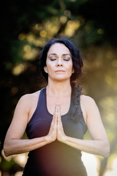 istock Brunette woman doing yoga in a park 1187309480