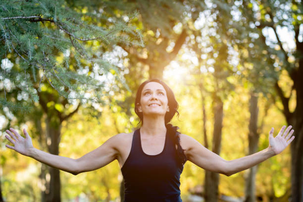 istock Brunette woman doing yoga in a park 1187309535