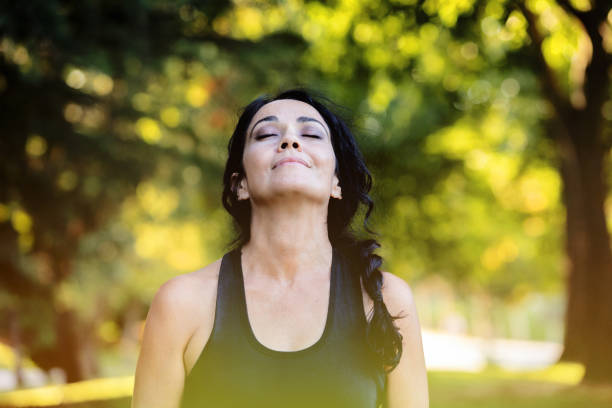 istock Brunette woman doing yoga in a park 1187309615