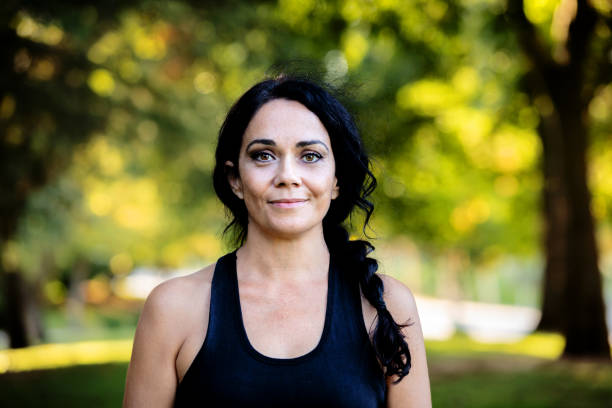 istock Brunette woman in a park 1187309669