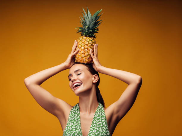 istock Beautiful girl with pineapple 1187309831