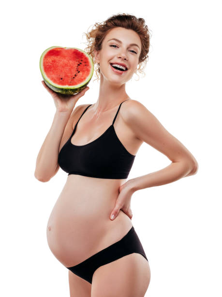 istock Pregnant woman holding a watermelon 1187311665