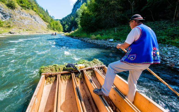 Sromowce Nizne, Poland - August 25, 2015. Dunajec River Gorge. Typical polish raftsman rafts tourists on the Dunajec river. The rafting near the Slovakian border is very popular tourist attraction