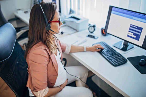 istock Pregnant woman working in the office 1187315067