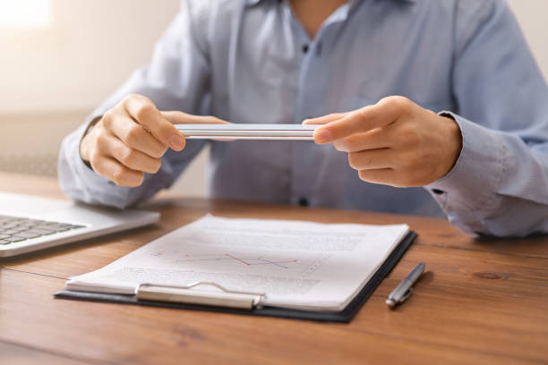 istock Man holding smartphone in horizontal orientation using scanner app 1187315481