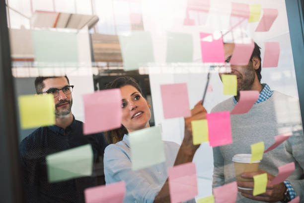 istock Diverse businesspeople brainstorming with together with adhesive notes 1187315747