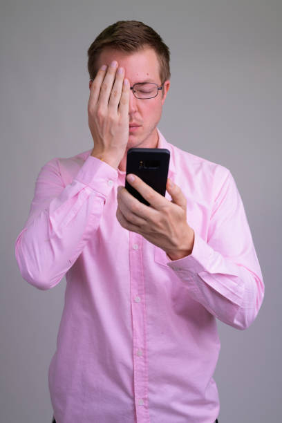 istock Young stressed businessman using phone and covering face 1187315825