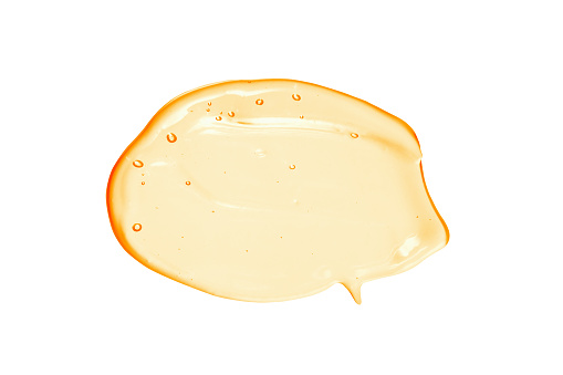 Suero de vitamina C, muestra de gel líquido cosmético de naranja transparente aislada sobre fondo blanco photo