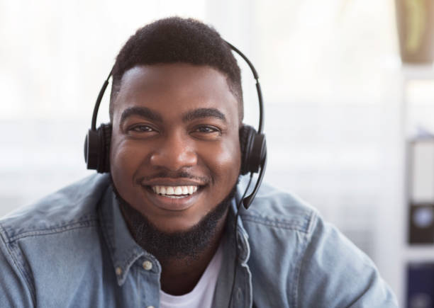 istock Portrait of friendly black customer support manager in headset 1187317328