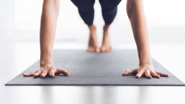 istock Slim woman practicing yoga in Plank pose, closeup 1187317698