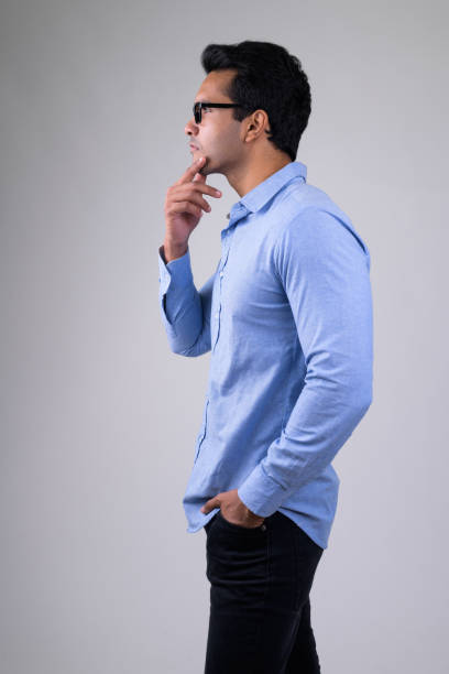 istock Profile view of young handsome Indian businessman thinking 1187318022