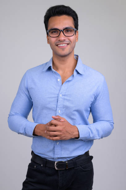 istock Happy young handsome Indian businessman smiling vertical shot 1187318161