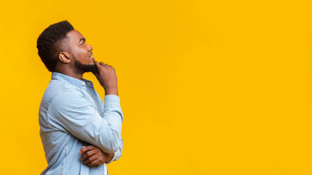 istock Black millennial man thinking about something and looking upwards 1187318226