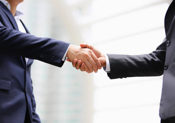istock Midsection Of Coworkers Shaking Hands While Standing Outdoors 1187319555