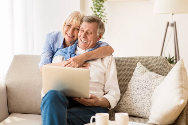 istock Happy mature sposes websurfing on laptop, resting at weekend 1187320410