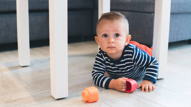 istock beautiful baby boy under the table 1187320423