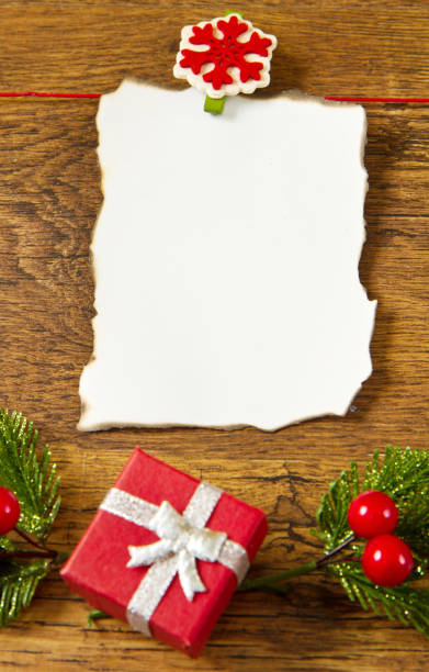 istock blank note with christmas decoration on wooden background 1187320998