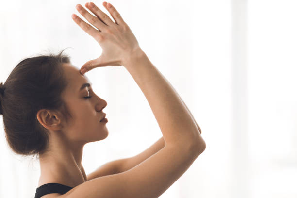 istock Yogi woman doing namaste gesture, hands to forehead 1187323228