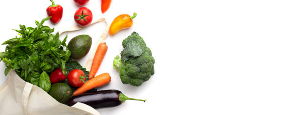 istock Organic vegetables in eco shopping bag on white background 1187323545