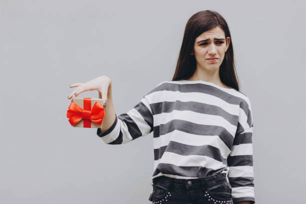 istock The girl is dissatisfied with the gift. 1187323633