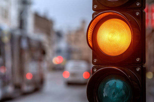 istock A city crossing with a semaphore. Orange light in semaphore - image 1187323975