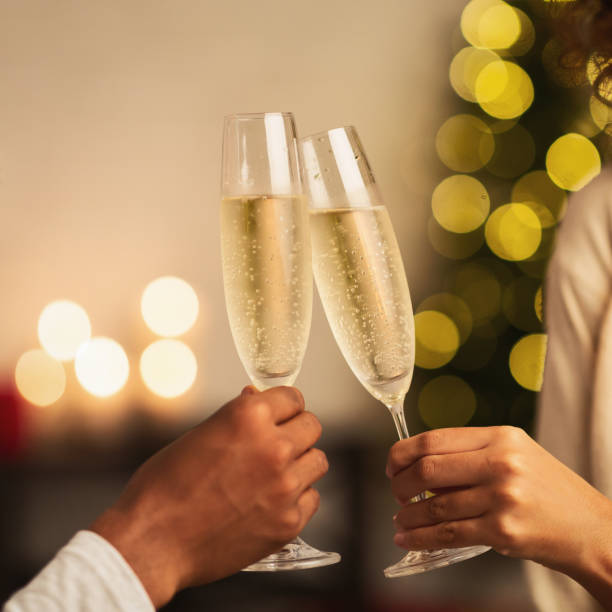 célébration de noel et du nouvel an. champagne de toastsing de couples - champagne celebration glass black photos et images de collection